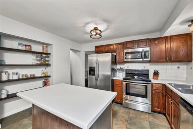 Kitchen has tile floors and back splash, updated l