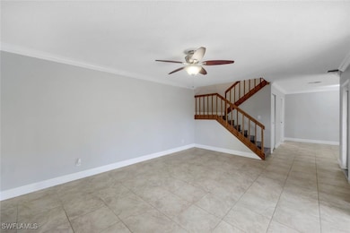 Empty room with stairs, a ceiling fan, ornamental