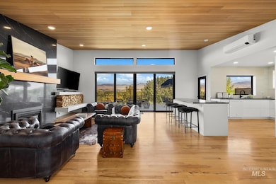 Living area featuring wooden ceiling, recessed lighting, a large fireplace, light wood finished floors, and a wall mounted AC