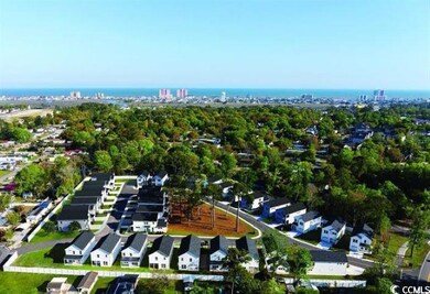 Aerial view of property and surrounding area with nearby suburban area