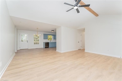 Living Room opens into Dining Room and Kitchen