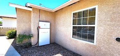 Entrance to property featuring fence and stucco si