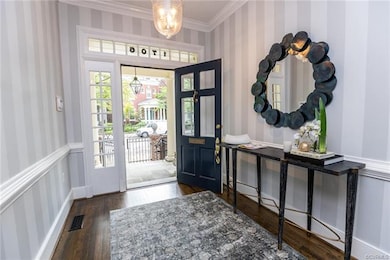 The transom and sidelights surrounding the front door fill the entrance hall with natural light.