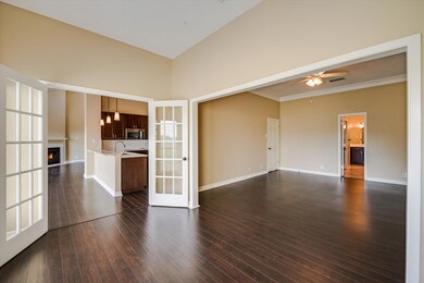 Unfurnished living room featuring ceiling fan, a 