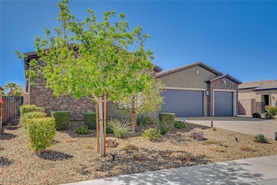 View of front of house with a garage, stone siding
