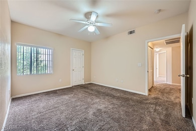 Empty room with carpet, a smoke detector, a ceilin