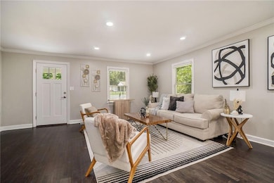 Living room with baseboards, wood finished floors,