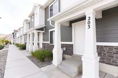 View of exterior entry featuring stone siding, a residential view, and a porch