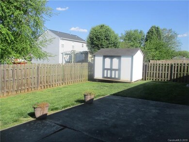 storage shed in fenced backyard