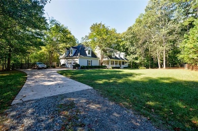 View of yard featuring concrete driveway