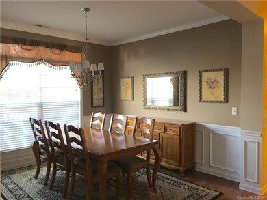Dining room with wainscoting and crown molding