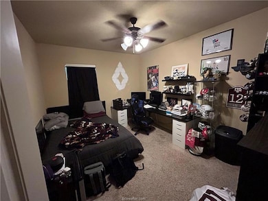 Bedroom featuring ceiling fan and carpet flooring