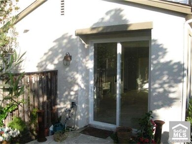Sliding doors open up to backyard patio.