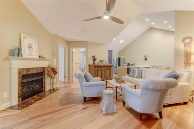 Living room with vaulted ceilings and gas logs.