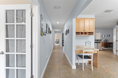 Front Entrance with view of Kitchen to the Right and Den/Bedroom to the Left