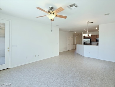 Unfurnished living room with a chandelier, ceiling fan, and recessed lighting