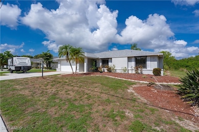 Ranch-style house featuring a garage, driveway, st
