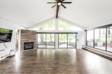 Large family room with tons of sliders and gas fir