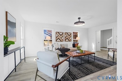 Living area with light wood-type flooring and stairway