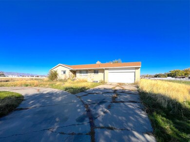 Ranch-style house with concrete driveway and an attached garage