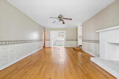 Unfurnished living room with ceiling fan, ornament