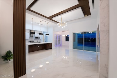 Kitchen featuring sink, an inviting chandelier, de