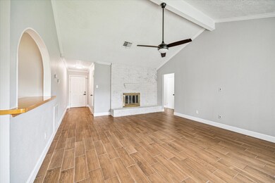 Open living room with white washed fireplace