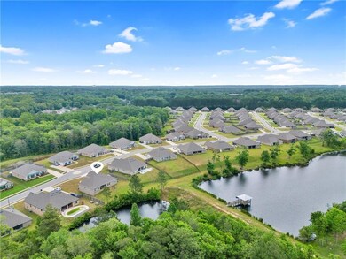 Birds eye view of property featuring a water view and a residential view