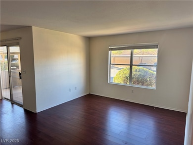Spare room featuring dark wood finished floors