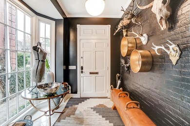 Entry with Ceramic Tile Floor, Exposed Brick and L