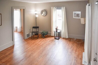 Spacious living room with newer laminate flooring.