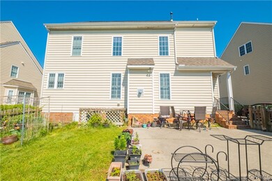 Rear view of property featuring a patio and a yard