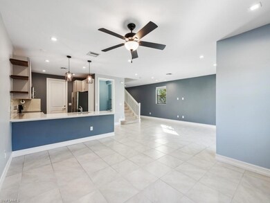 Unfurnished living room featuring ceiling fan and 