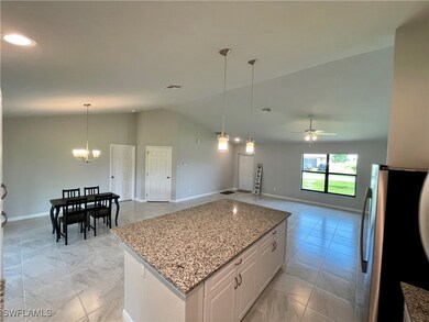 Kitchen featuring white cabinets, ceiling fan with