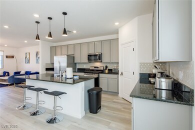 Kitchen with stainless steel appliances, light woo