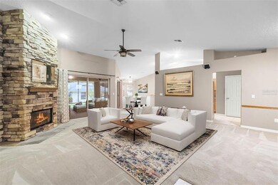 Wood burning fireplace with floor to ceiling stone accent. (Virtually Staged)