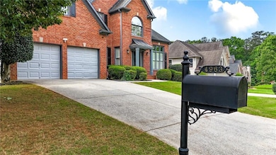 Traditional home featuring brick siding, driveway, and a front lawn
