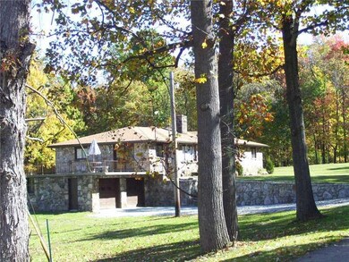 Exterior Front. 2 car garage with concrete deck of