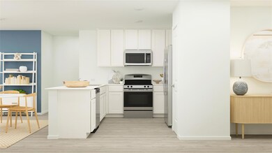 Kitchen featuring stainless steel appliances, white cabinetry, light wood-type flooring, kitchen peninsula, and a baseboard radiator