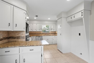 This kitchen features freshly painted cabinetry, n