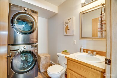Just outside the kitchen (and right inside the back door from the garage) you'll find the convenient main floor half bath with a stackable washer/dryer. Note: Washer/dryer set was new in 2022: not included in sale, but seller is willing to negotiate.