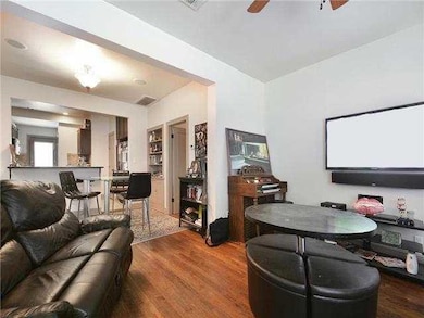 Living room featuring wood finished floors and a ceiling fan