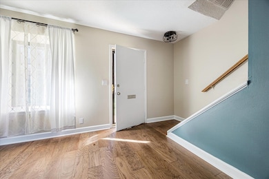 Entrance foyer featuring wood finished floors and a textured ceiling