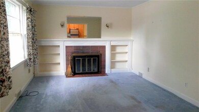 Living room with built-ins and fireplace