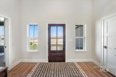 Foyer entrance with wood finished floors