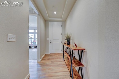 Corridor with light wood finished floors, a textur