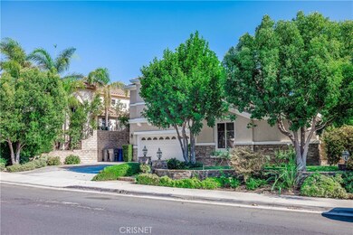 Front of home with mature trees.