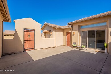 Courtyard toward gate and garage door an