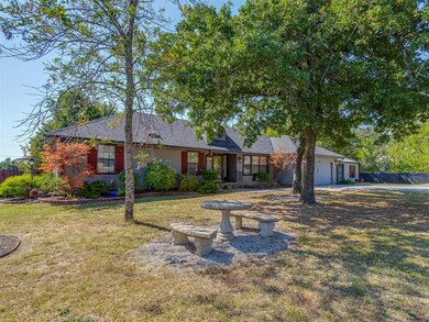 Ranch-style house featuring a garage and a front lawn