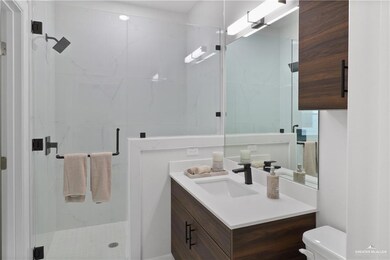 Bathroom with vanity, toilet, and a shower with door